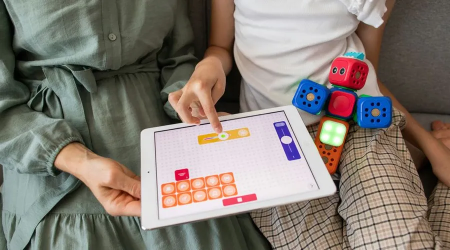 Child playing and learning with digital and hands-on technology